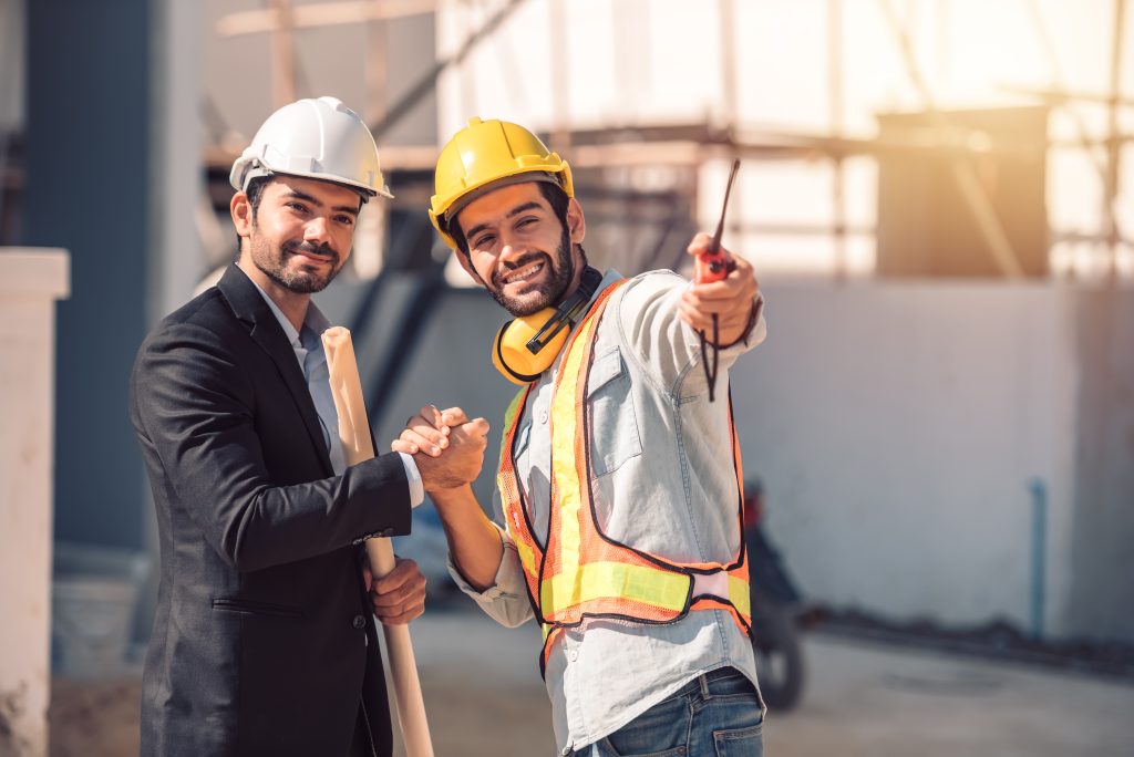 happy workers construction site young civil engineer manager architects handshaking construction site looking construction phase cooperation teamwork concept